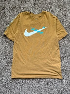 Nike Men's Mustard Yellow Graphic Swoosh Tee with Teal Accents